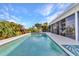 Outdoor pool area with tiled patio and a screen enclosed lanai for outdoor living at 82 Caddy Rd, Rotonda West, FL 33947