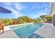 Backyard pool surrounded by lush landscaping offers a private outdoor oasis at 82 Caddy Rd, Rotonda West, FL 33947
