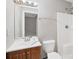 Functional bathroom equipped with a single vanity, toilet, and a shower with a white enclosure at 8706 Fish Lake Rd, Tampa, FL 33619