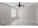 Neutral bedroom featuring a ceiling fan, a window, and tile flooring, providing a blank canvas at 8706 Fish Lake Rd, Tampa, FL 33619