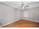 Comfortable bedroom featuring wood look flooring, ceiling fan and a window for natural light at 8706 Fish Lake Rd, Tampa, FL 33619
