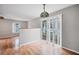 Open dining area featuring wood flooring, a modern light fixture, and sliding doors to the backyard at 8706 Fish Lake Rd, Tampa, FL 33619