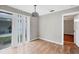 Bright dining area featuring sliding glass doors, wood flooring, and a decorative hanging light fixture at 8706 Fish Lake Rd, Tampa, FL 33619