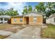 This single-story home has a front lawn, driveway, and classic exterior at 8706 Fish Lake Rd, Tampa, FL 33619