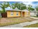 Charming single-story home featuring a stucco exterior, a concrete driveway, and a well-maintained yard at 8706 Fish Lake Rd, Tampa, FL 33619