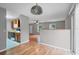 Open-concept living room featuring wood flooring, bright windows, and seamlessly connected to the kitchen area at 8706 Fish Lake Rd, Tampa, FL 33619