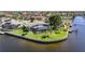 Waterfront home with screened lanai, lush lawn, mature trees, and private dock at 955 Don Juan Ct, Punta Gorda, FL 33950
