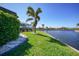 Waterfront backyard with lush landscaping and private access to the canal at 955 Don Juan Ct, Punta Gorda, FL 33950