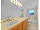 Bathroom featuring double sinks, wooden cabinets, and bright natural light at 955 Don Juan Ct, Punta Gorda, FL 33950