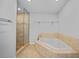 Bathroom showcasing a walk-in shower with glass door, jetted tub, and decorative tile at 955 Don Juan Ct, Punta Gorda, FL 33950