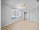 Bedroom with tile flooring, ceiling fan, closet and bright window with gray curtains at 955 Don Juan Ct, Punta Gorda, FL 33950