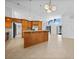Open-concept kitchen boasts a breakfast bar, wood cabinetry, and stainless steel appliances at 955 Don Juan Ct, Punta Gorda, FL 33950