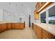 Spacious kitchen with tile floor, wood cabinets, and an eat-in bar at 955 Don Juan Ct, Punta Gorda, FL 33950