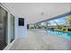 Covered patio with brick flooring and a screened enclosure overlooking a sparkling pool and peaceful canal at 955 Don Juan Ct, Punta Gorda, FL 33950