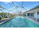 Covered pool with screened enclosure offers clear views of the serene canal and tropical landscaping at 955 Don Juan Ct, Punta Gorda, FL 33950