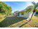Side view of the house shows a screened in porch/pool with large backyard and mature landscaping at 1065 Harbour Glen Pl, Punta Gorda, FL 33983