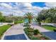 Beautiful Harbour Oaks community entrance featuring lush landscaping and a secure gate at 1065 Harbour Glen Pl, Punta Gorda, FL 33983