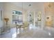 Bright dining room featuring a glass table, chandelier, and white tiled floors at 1065 Harbour Glen Pl, Punta Gorda, FL 33983