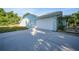 Garage exterior featuring a well-maintained driveway, two car garage and blue exterior at 1065 Harbour Glen Pl, Punta Gorda, FL 33983