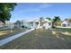 Inviting single-story home with beautiful landscaping, large windows, and a welcoming entrance at 1065 Harbour Glen Pl, Punta Gorda, FL 33983