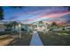 Charming single-story home with manicured lawn, palm trees and inviting front entrance at 1065 Harbour Glen Pl, Punta Gorda, FL 33983