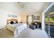 Bedroom boasts a tray ceiling, a ceiling fan and a sliding door to the lanai at 1065 Harbour Glen Pl, Punta Gorda, FL 33983