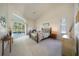Vaulted primary bedroom featuring a king bed and sliding glass doors to pool at 1065 Harbour Glen Pl, Punta Gorda, FL 33983