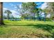 A view of the playground, picnic tables, and tennis courts on a grassy lawn at 1065 Harbour Glen Pl, Punta Gorda, FL 33983