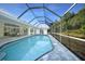 Beautiful screened-in pool area with a clear blue pool and surrounding deck at 1065 Harbour Glen Pl, Punta Gorda, FL 33983