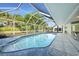 A screened-in pool boasts a clear blue pool and ample surrounding space for relaxation at 1065 Harbour Glen Pl, Punta Gorda, FL 33983