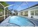 A refreshing screened-in pool area with ample seating, perfect for relaxation and entertaining at 1065 Harbour Glen Pl, Punta Gorda, FL 33983