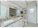 Bathroom featuring double sinks, a shower, toilet and door to the outside at 1311 Pine Siskin Dr, Punta Gorda, FL 33950