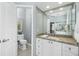 Well-lit bathroom featuring a granite countertop vanity, a toilet, and neutral tile floors for a clean look at 1311 Pine Siskin Dr, Punta Gorda, FL 33950