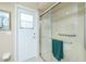 Bathroom featuring a glass enclosed shower and a door to the outside at 1311 Pine Siskin Dr, Punta Gorda, FL 33950