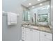 Elegant bathroom features a granite countertop vanity with ample storage and an illuminated mirror at 1311 Pine Siskin Dr, Punta Gorda, FL 33950