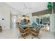 Bright and open dining area with access to the kitchen, pool, and front door, featuring modern lighting and neutral colors at 1311 Pine Siskin Dr, Punta Gorda, FL 33950