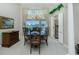 Elegant dining room featuring large windows with a view of the pool and stylish chandelier lighting at 1311 Pine Siskin Dr, Punta Gorda, FL 33950