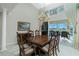 Elegant dining room with a chandelier, dark wood furniture, and access to the pool area at 1311 Pine Siskin Dr, Punta Gorda, FL 33950