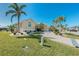 Beautifully landscaped front yard with mature palm trees and a long driveway leading to a spacious three-car garage at 1311 Pine Siskin Dr, Punta Gorda, FL 33950