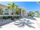 Attractive home exterior boasting a lush lawn, trimmed bushes, palm trees, and a paved driveway at 1311 Pine Siskin Dr, Punta Gorda, FL 33950