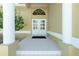 Elegant front entrance with classic double doors, white tile flooring, and grand columns for a welcoming feel at 1311 Pine Siskin Dr, Punta Gorda, FL 33950