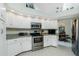 Kitchen with white cabinets, stainless steel appliances, granite counters and eat in breakfast area at 1311 Pine Siskin Dr, Punta Gorda, FL 33950