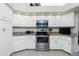 Well-lit kitchen featuring white cabinets, granite countertops, and stainless steel appliances at 1311 Pine Siskin Dr, Punta Gorda, FL 33950