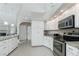 Bright kitchen with white cabinets, stainless steel appliances, granite countertops and open design at 1311 Pine Siskin Dr, Punta Gorda, FL 33950