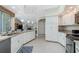 Open kitchen featuring white cabinets, granite countertops, and stainless steel appliances at 1311 Pine Siskin Dr, Punta Gorda, FL 33950