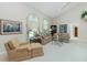 Bright living room featuring vaulted ceilings, plush sofas, and arched windows with decorative curtains at 1311 Pine Siskin Dr, Punta Gorda, FL 33950
