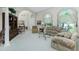 Comfortable living room with vaulted ceilings, neutral tones, and large windows providing natural light at 1311 Pine Siskin Dr, Punta Gorda, FL 33950