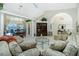 Expansive living room with a seamless transition to dining area and view of the outdoor pool area at 1311 Pine Siskin Dr, Punta Gorda, FL 33950