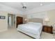 Bright main bedroom with a ceiling fan, neutral walls, and access to the main bath and walk-in closet at 1311 Pine Siskin Dr, Punta Gorda, FL 33950