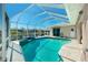 Enjoy stunning water views from the screened-in pool with blue tiled accents and plenty of lounging space at 1311 Pine Siskin Dr, Punta Gorda, FL 33950